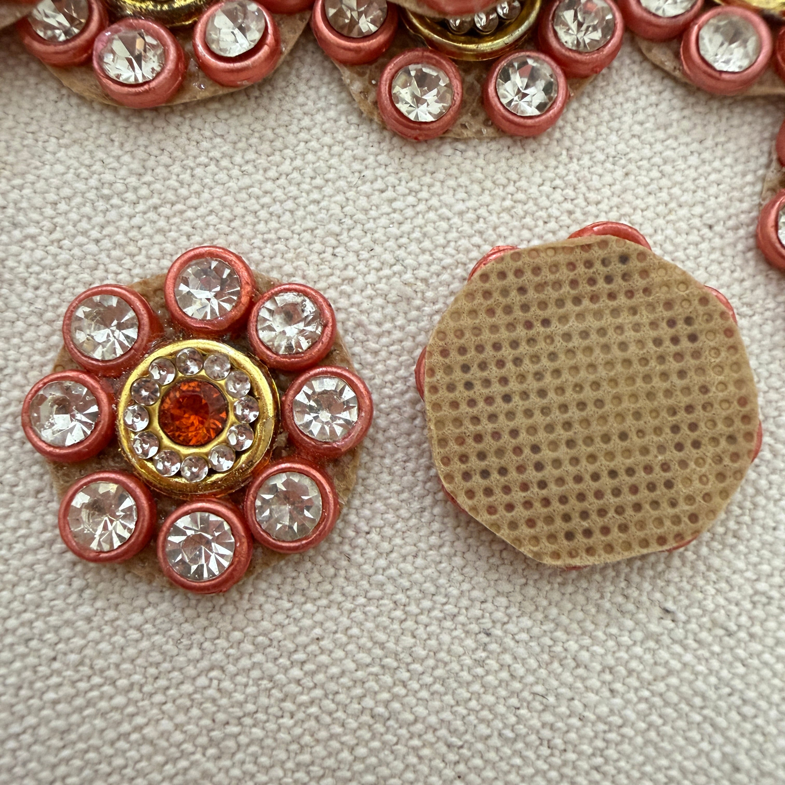 Decorative button with gemstones on a textured surface