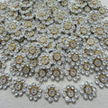 Close-up of decorative buttons with gemstones on a textured fabric background