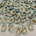 Collection of green and gold beaded paisley designs on a beige background