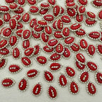 Red embellishments with rhinestones on a light fabric background