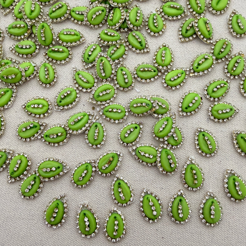 Pattern of green decorative elements with silver accents on a light gray background