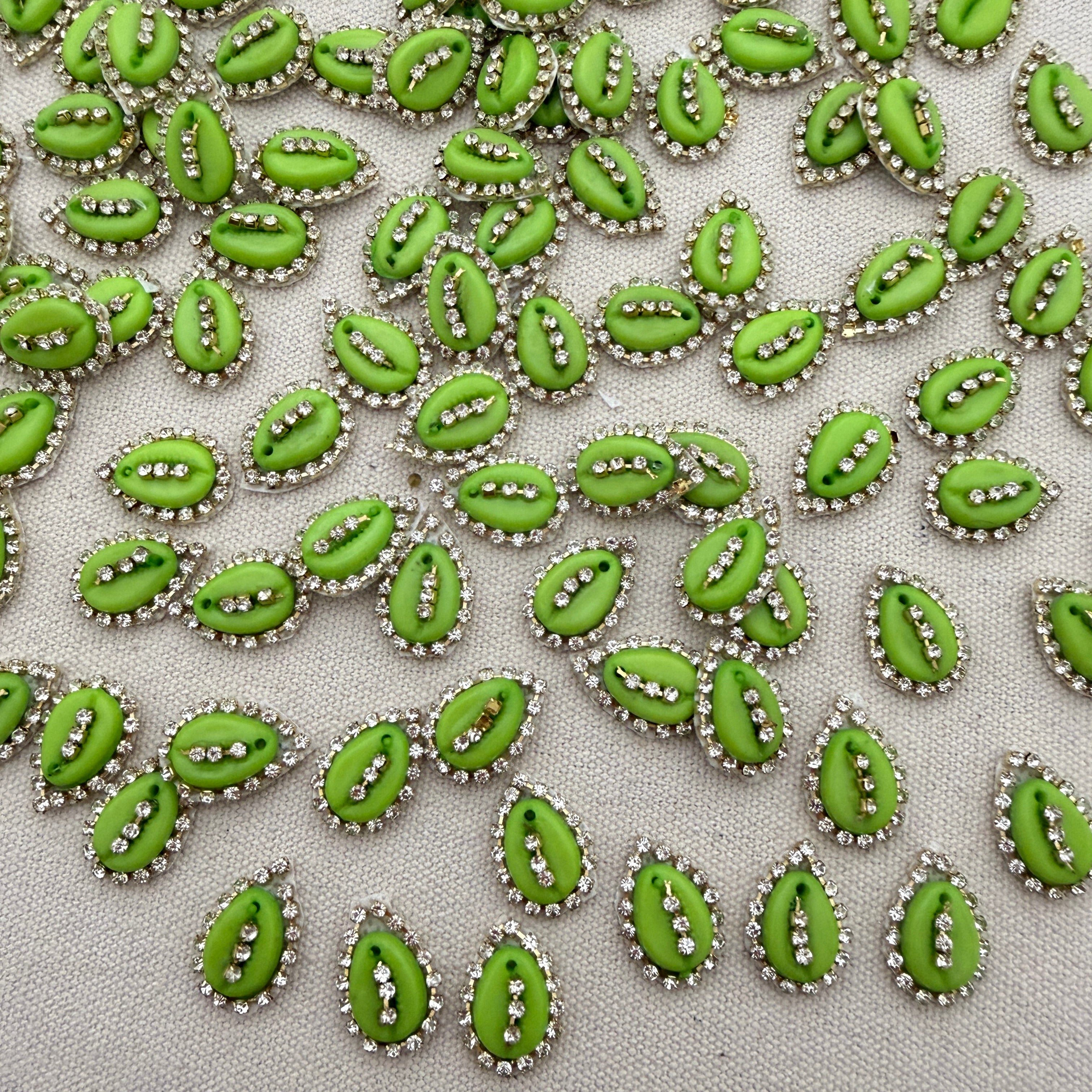 Pattern of green decorative elements with silver accents on a light gray background