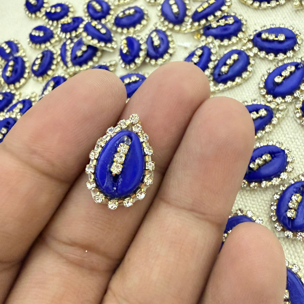 Blue decorative element on a hand with a patterned background
