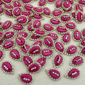 Pink lip-shaped embellishments with rhinestones on a light gray background