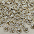 Close-up of decorative buttons with pearls and crystals on a beige fabric background