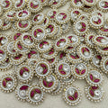 Close-up of decorative elements with pearls, red stones, and gold accents on a beige background