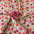Floral embroidered fabric with a pink rose on top