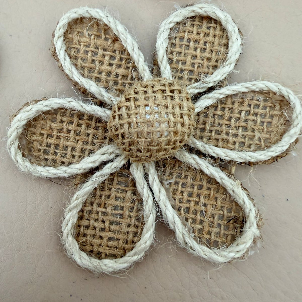 Close-up of burlap daisy flower patch with twisted white rope border