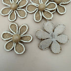 Multiple burlap daisy flower patches laid out flat