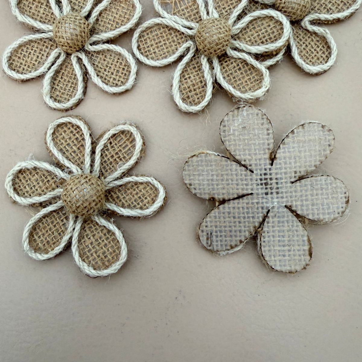 Multiple burlap daisy flower patches laid out flat