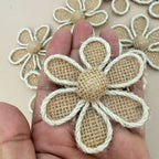 Burlap daisy flower patch held in hand showing size and texture