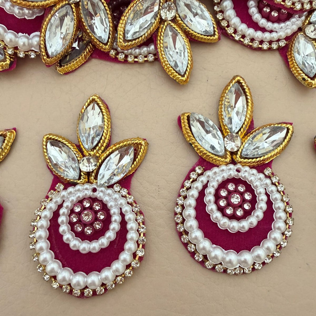 Multiple Magenta Kundan Pearl Crystal Applique Patches laid flat showing bulk quantity