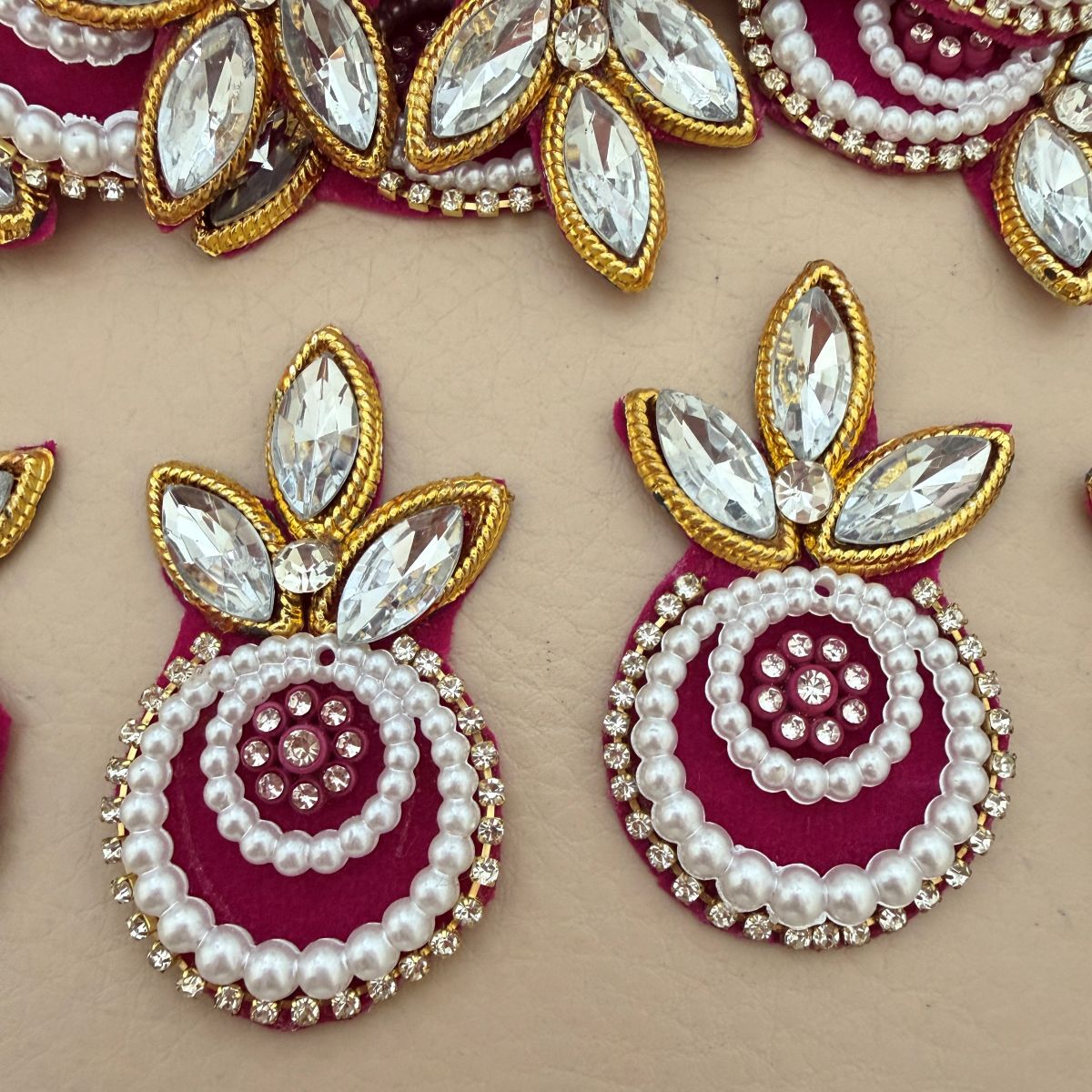 Multiple Magenta Kundan Pearl Crystal Applique Patches laid flat showing bulk quantity