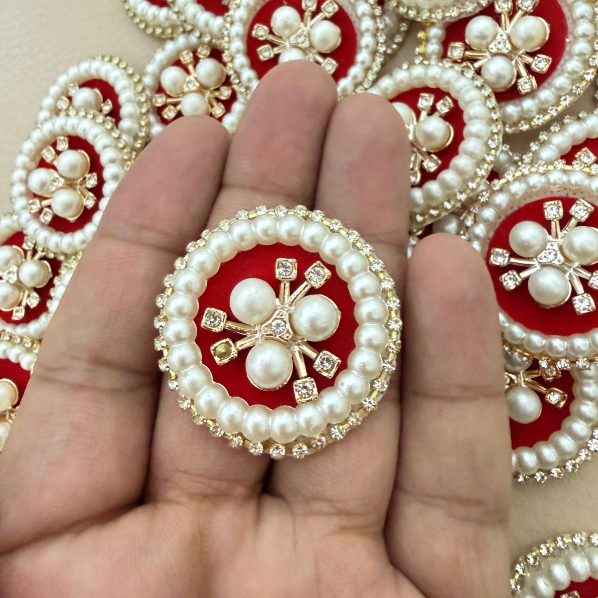 Front and back view of round pearl rhinestone patch showing non-woven backing