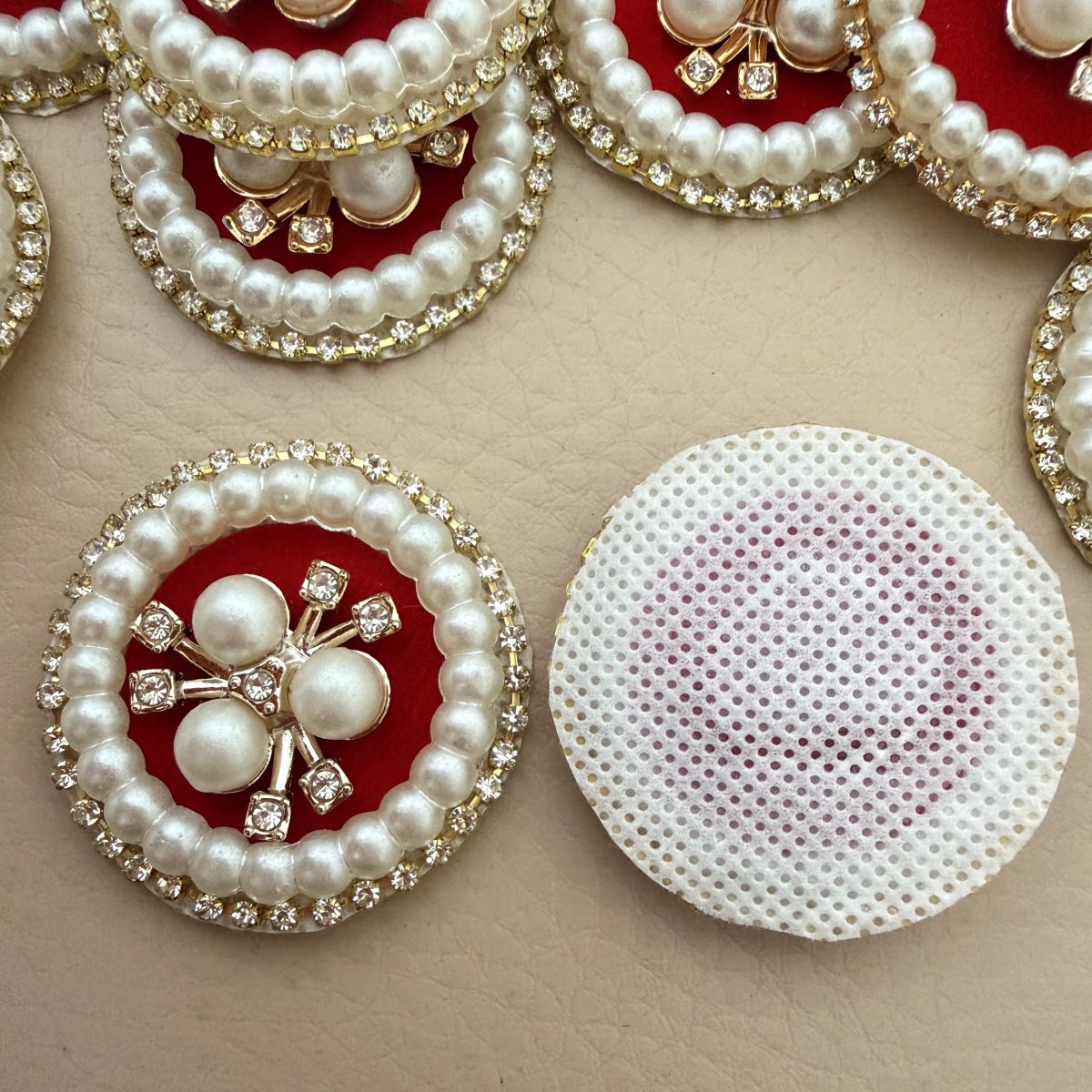 Pearl rhinestone patch held in hand showing scale