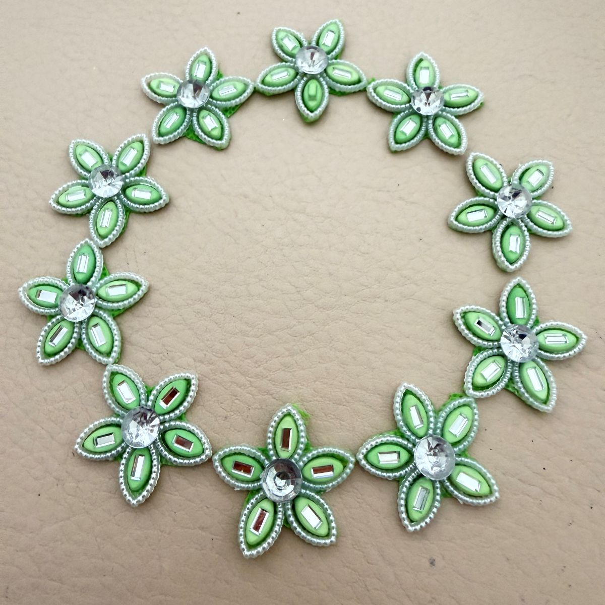 Mint green rhinestone flower patches bulk view
