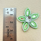 Close-up of two green rhinestone flower patches