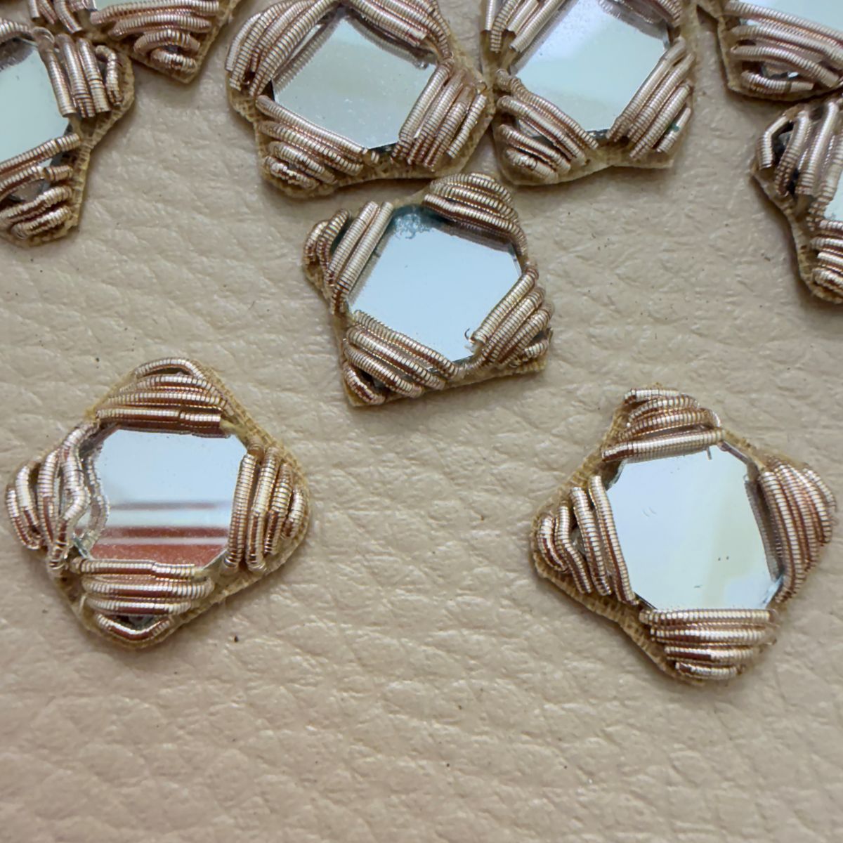 Antique gold square mirror applique patch held in hand showing scale