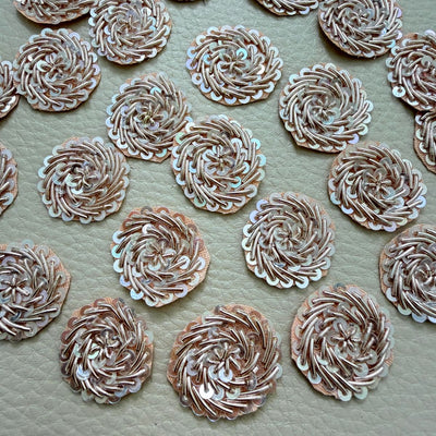 Front and mesh backing of rose gold metallic coil and iridescent sequin floral patches