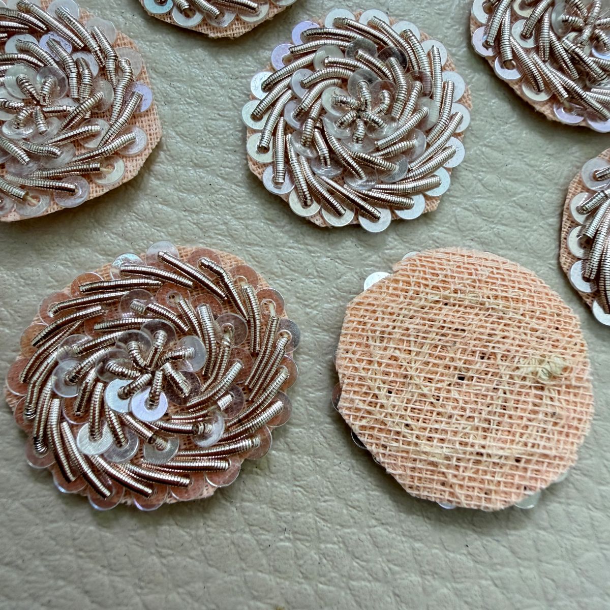 Rose gold sequin floral patch beside ruler measuring approximately 2.5 cm across