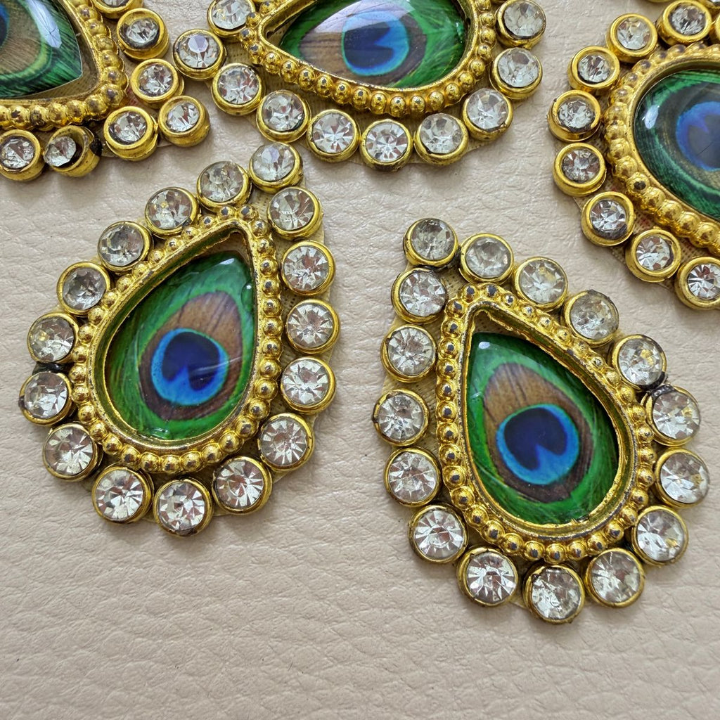 Peacock-eye teardrop rhinestone patch beside ruler showing approximately 4.5 cm length