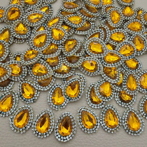Multiple amber gold teardrop rhinestone patches shown together