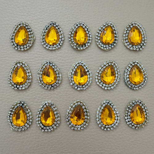 Amber gold teardrop rhinestone patches arranged in rows