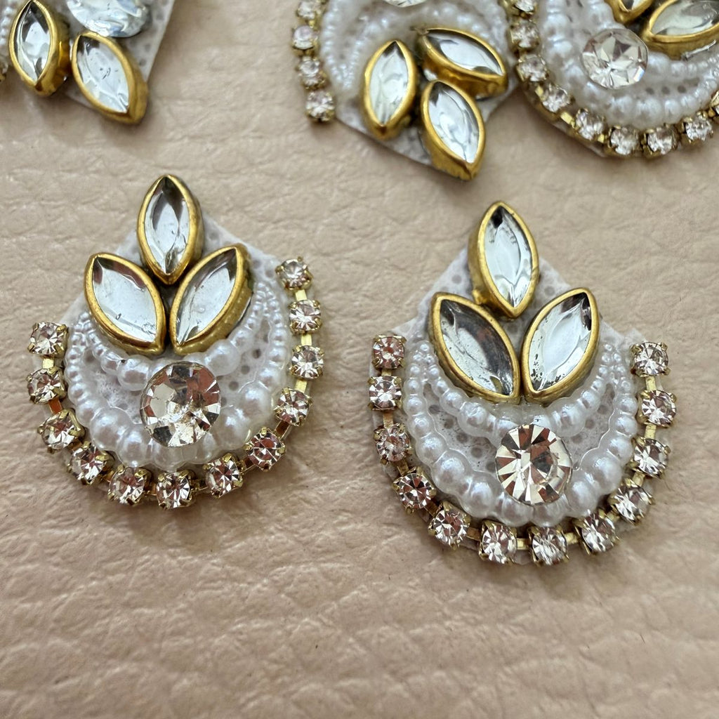 White beaded rhinestone crescent patch shown in hand for scale