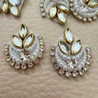 White beaded rhinestone crescent patch shown in hand for scale