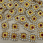Front and back view of ruby red square patch with clear rhinestones and gold-tone frame