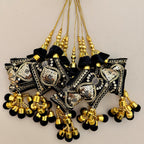 Black and gold sequin tassel pair shown beside a ruler for scale