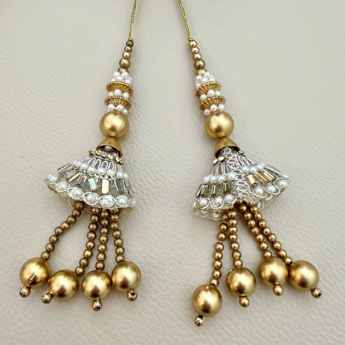 Group of ornate gold and silver pearl latkan tassels with dangling beads