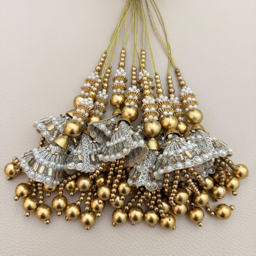 Gold and silver pearl latkan tassel pair beside ruler showing approximate size