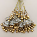 Gold and silver pearl latkan tassel pair beside ruler showing approximate size