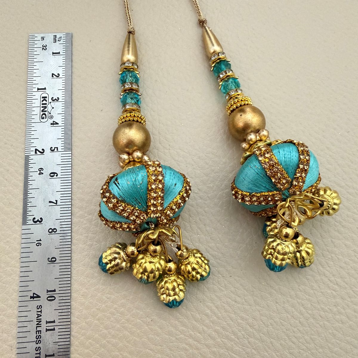 Multiple turquoise, teal and antique gold decorative latkan tassels
