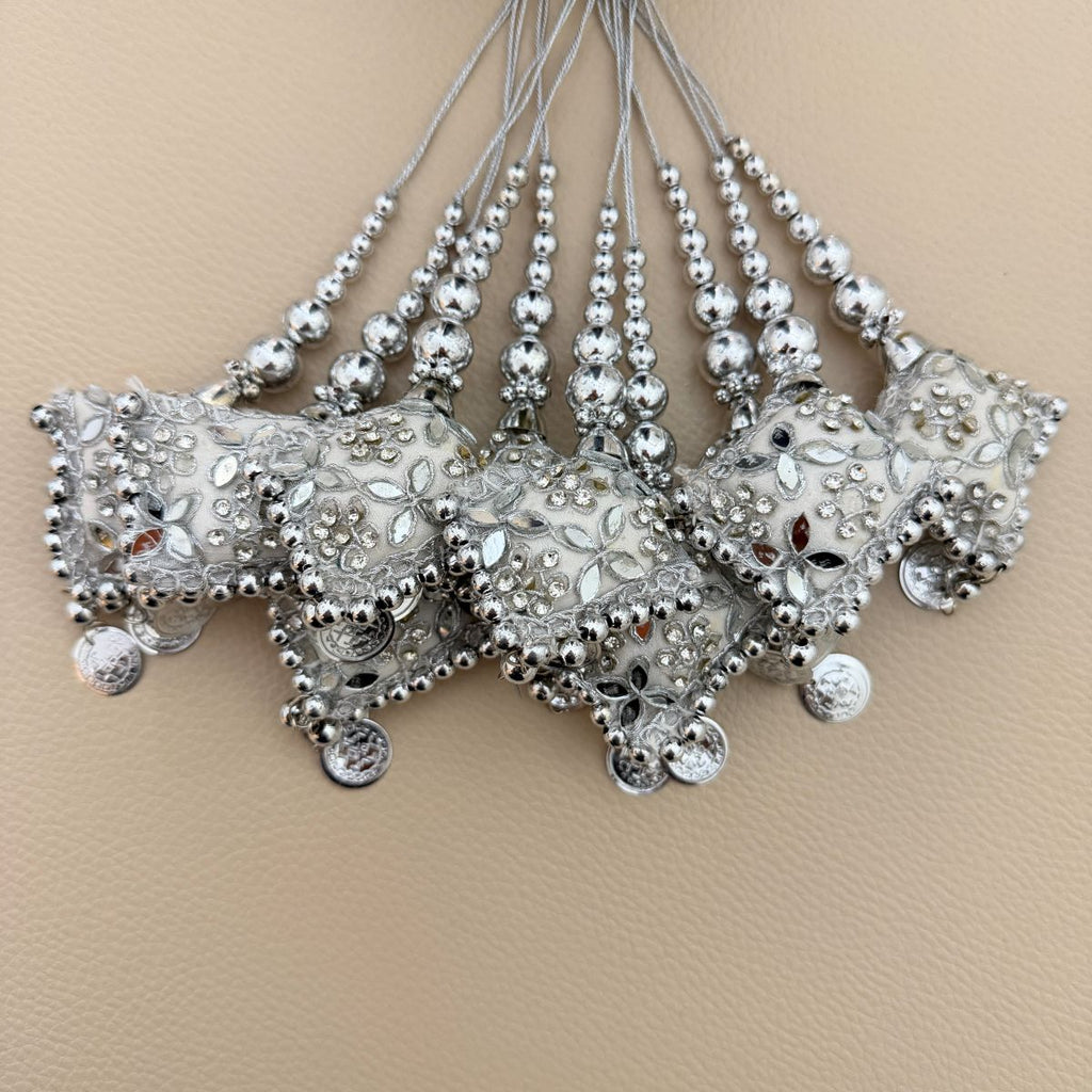 Group of silver embroidered decorative latkan tassels with beads, mirrors and coin-style charms
