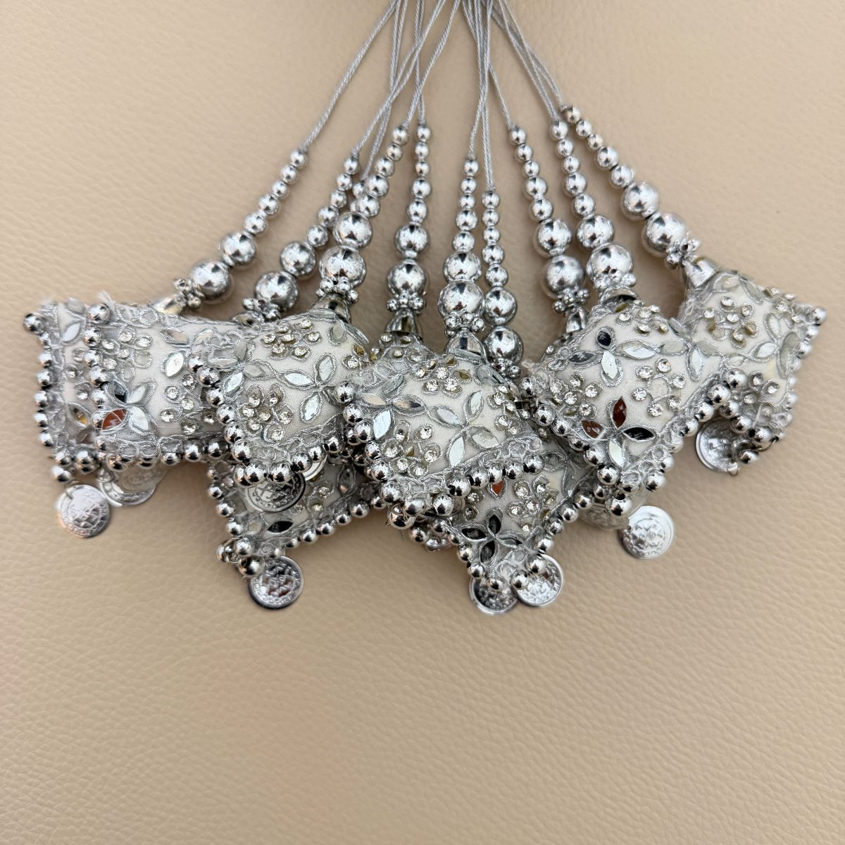 Group of silver embroidered decorative latkan tassels with beads, mirrors and coin-style charms
