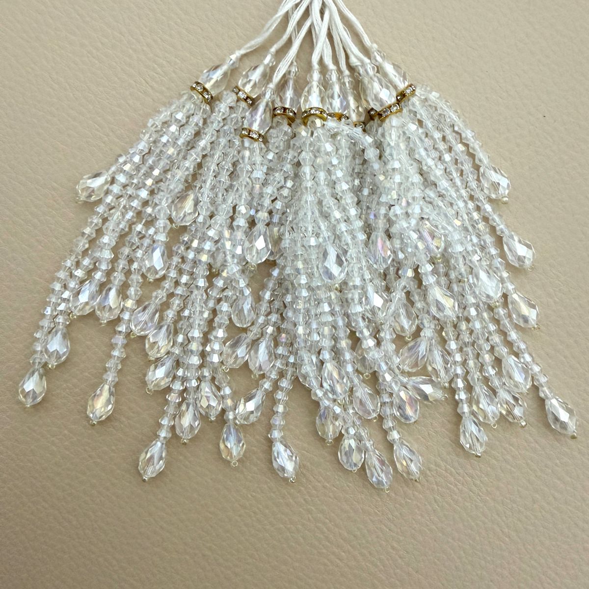 Close view of graduated beaded strands with faceted teardrop tips