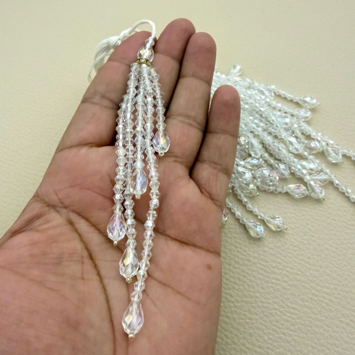 Detail of faceted crystal bead strands and gold rhinestone ring