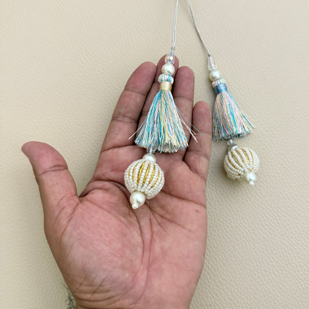 Group of pastel thread latkan tassels with white seed-bead ball drops