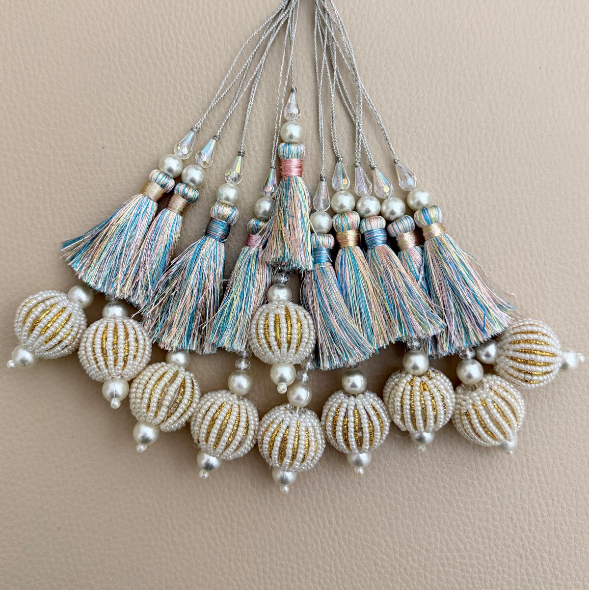 Pastel multicolor thread latkan tassel held in hand to show size and detailing
