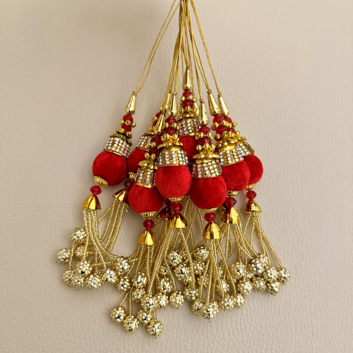 Group of matching red and gold beaded chain latkan tassels for decorative use