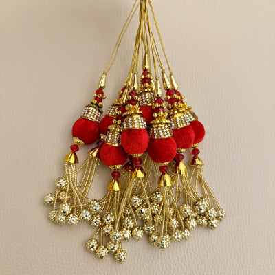 Group of matching red and gold beaded chain latkan tassels for decorative use