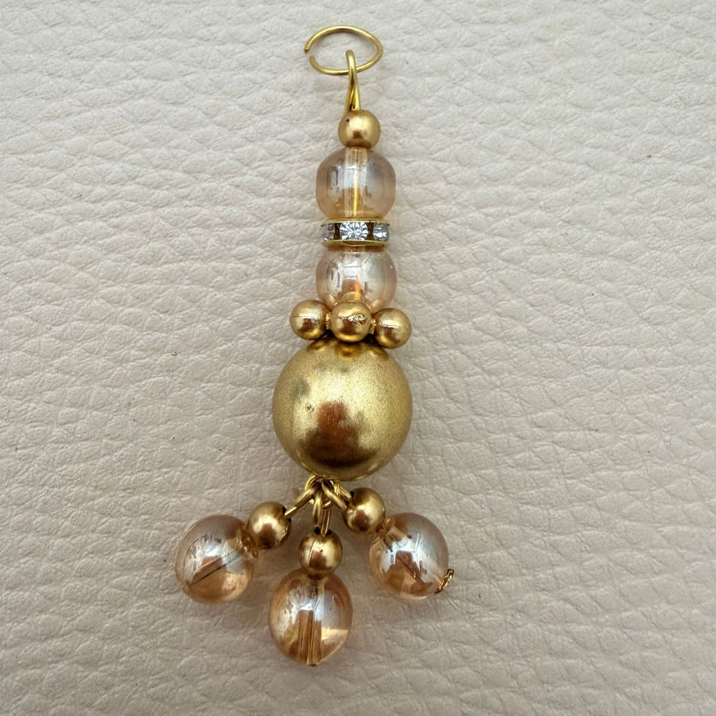 Gold tone beaded latkan with clear faceted beads and clustered dangles
