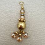 Gold tone beaded latkan with clear faceted beads and clustered dangles
