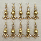 Single gold tone latkan showing clear beads, rhinestone spacer, and brushed gold center bead