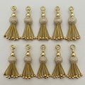 Ten gold metallic beaded tassel charms arranged in two rows
