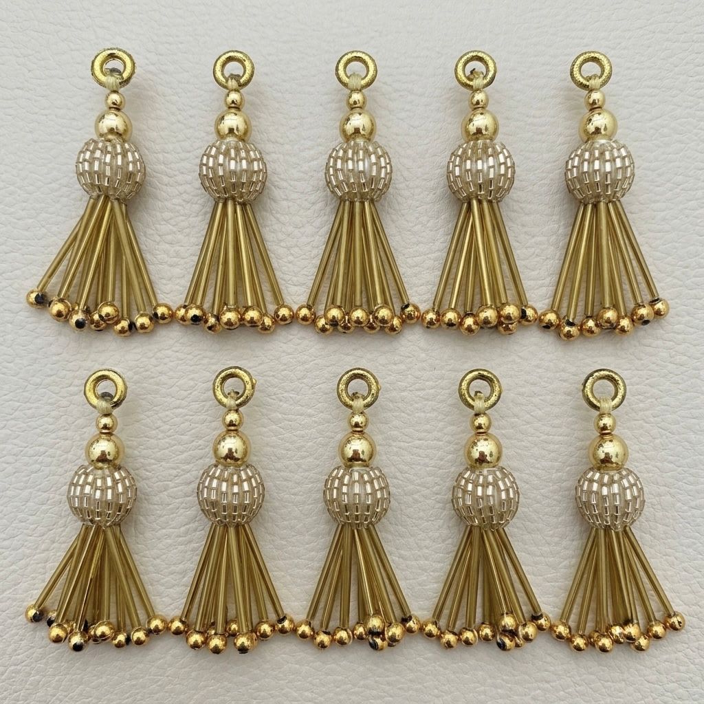 Ten gold metallic beaded tassel charms arranged in two rows
