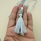 Bundle of silver silk tassels showing beaded caps
