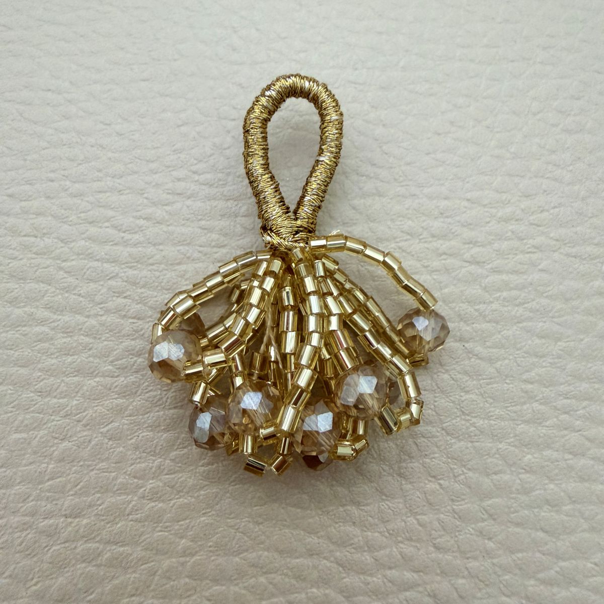 Gold crystal bead bunch latkan close-up showing metallic loop, gold bugle beads and clear faceted crystal drops